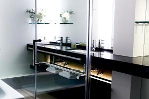 a bathroom with two sinks and a glass shower at Hotel New Otani Osaka in Osaka