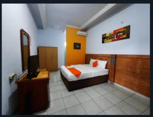 Postel nebo postele na pokoji v ubytování deSERUNI Guest House Kerobokan