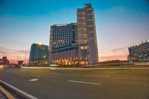 a city street with a tall building in the background at Kingsford Hotel Manila Bay in Manila +36 photos