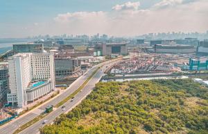 an aerial view of a city with a highway at Kingsford Hotel Manila Bay in Manila