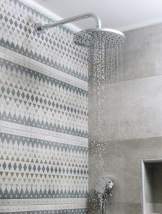 a shower with a shower head in a bathroom at Grand Sea View Luxury Villa in Kalamaki Heraklion +59 photos
