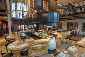 a restaurant with tables and chairs in a room at Boutique-Hotel LARTOR in Unterammergau