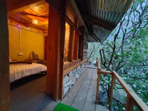 a bedroom in a house with a bed on a porch at Yalakhom in Kalgha