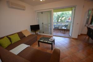 a living room with a couch and a table at Apartment Silva in Kornić