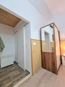 a room with a wooden door and a mirror at Studio Heart of the Town in Dubrovnik