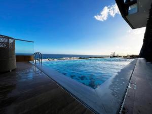 a swimming pool with a view of the ocean at Luxury Private Apartments - Limassol in Limassol