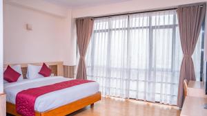 Letto o letti in una camera di Drishya Hotel