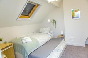 a small bedroom with a bed and a window at High Peak Place - Spacious Whaley Bridge Townhouse in Whaley Bridge