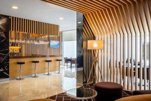 a lobby with a bar with stools at HF Fénix Urban in Lisbon