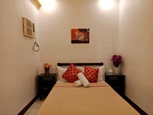 Postel nebo postele na pokoji v ubytování Amax Inn Cebu