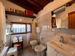 a bathroom with a white toilet and a sink at La Baita Di San Massimo in Rapallo