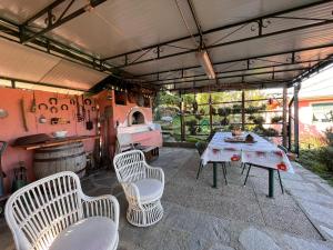 a patio with a table and chairs and a stove at La Baita Di San Massimo in Rapallo