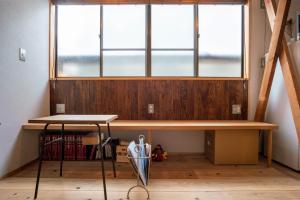 a desk in a room with a large window at Backpackers Hostel TSUBAMENOYADO in Shizuoka