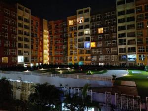 a view of a large building at night at Garden View 1 BHK2BR Appt., Rio De Goa TATA Housing in Sancoale