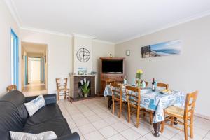 a living room with a table and a tv at Odessa in Lanton