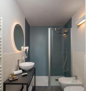 a bathroom with a shower and a sink and a mirror at Camere Relais Filomare in Marcelli