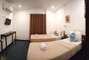 Postel nebo postele na pokoji v ubytování Amax Inn Cebu