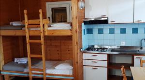 a kitchen with two bunk beds and a sink at Le Dune Villaggio in Lido Di Fondi