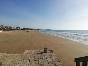a view of a sandy beach with the ocean at Happy Home in Pozzallo +14 photos