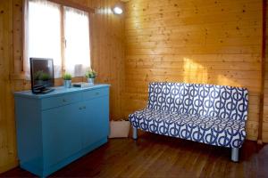 a room with a couch and a tv and a chair at Le Dune Villaggio in Lido Di Fondi