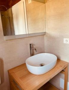 a white sink on a wooden counter in a bathroom at Le Dune Villaggio in Lido Di Fondi