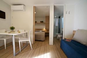 a living room with a white table and a couch at Le Dune Villaggio in Lido Di Fondi