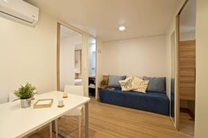 a living room with a couch and a table at Le Dune Villaggio in Lido Di Fondi
