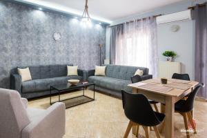 a living room with a couch and a table at Eva's House Project by Homebrain in Alexandroupoli