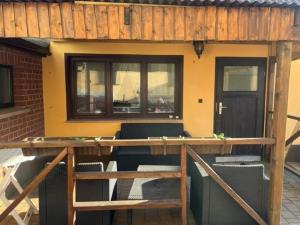 a house with a porch with a table and chairs at Gästehaus Leon in Lutherstadt Wittenberg