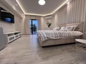 a bedroom with a bed and a television in it at מבט אל הואדי in Abū Ghaush +29 photos