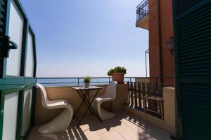 d'un balcon avec une table et des chaises donnant sur l'océan. dans l'établissement appartamento fronte mare con terrazzo, à Alassio
