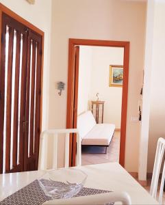 ein Wohnzimmer mit einem Tisch und einem Stuhl in der Unterkunft Il Fenicottero Rosa Casa Sanzio in Quartu SantʼElena