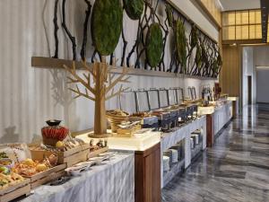 a buffet line with many different types of food at Garrya Huzhou Lucun in Huzhou