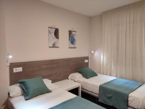 Postel nebo postele na pokoji v ubytování Hostal Garamar