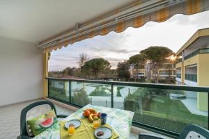 a balcony with a table with food on it at Residenza Le Altane in Bibione +17 photos
