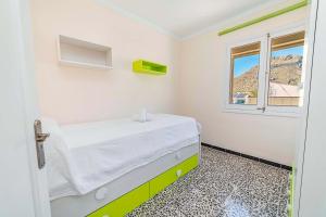 a hospital room with a bed and a window at Seafront Apartment Voramar 31 by Sealand Villas in Port de Pollensa