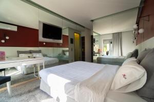 a bedroom with a large white bed and a bathroom at X Dream Hotel-Adults Only in Athens