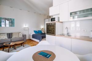 a kitchen and living room with a couch and a table at AMOROZO APARTMENTS by DuHomes in Dubrovnik