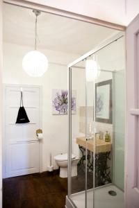 a bathroom with a glass shower and a toilet at Maison Bellachonne in Bellac