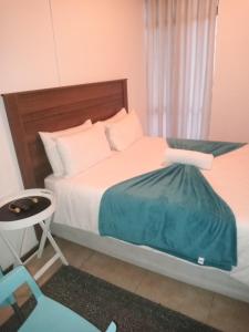 Ένα ή περισσότερα κρεβάτια σε δωμάτιο στο PARK FRONT LODGE