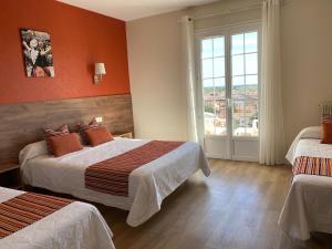 Postel nebo postele na pokoji v ubytování Hôtel Le Belvedere