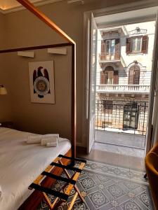 a bedroom with a bed and a large window at B&B TIVÌTTI in Palermo
