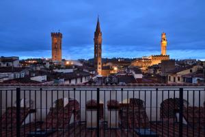 a view of a city at night with towers at Palazzo Portinari Salviati Residenza D'Epoca in Florence