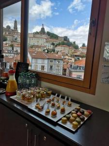 a table topped with plates of food and drinks at ibis Styles Le Puy en Velay in Le Puy-en-Velay