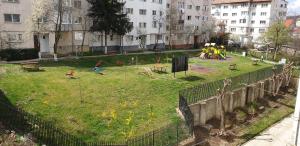 a park with children playing in the grass at Vio apartament in Zalău