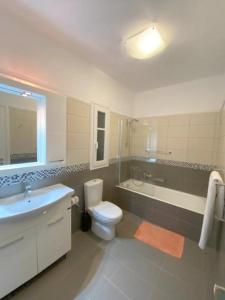 a bathroom with a sink and a toilet and a bath tub at My Lefkada Boutique Villa by Olga Lounge Hotel - Panoramic View - VISIT THE REAL PARADISE !!! in Lygia