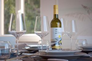 a bottle of wine sitting on a table with glasses at Harbor apartments 2 in Opatija