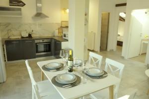 a white table with white chairs in a kitchen at Harbor apartments 2 in Opatija