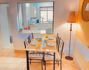 a dining room with a table and chairs and a kitchen at Albufeira Praia São Rafael Sun Apartment in Albufeira