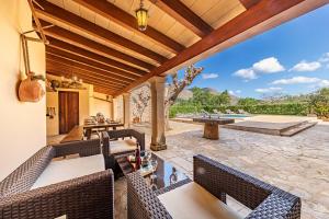 an outdoor patio with wicker chairs and a table at Villa Prital by Sealand Villas in Pollença +41 photos